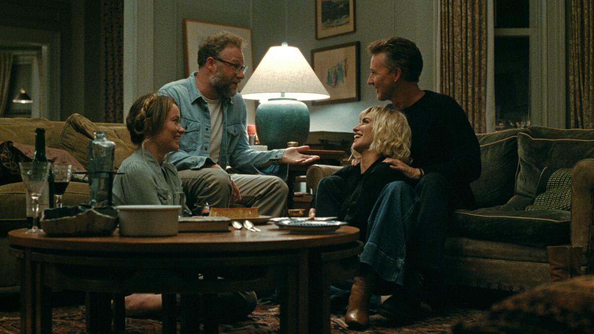 The four leads of The Invite around a dinner table