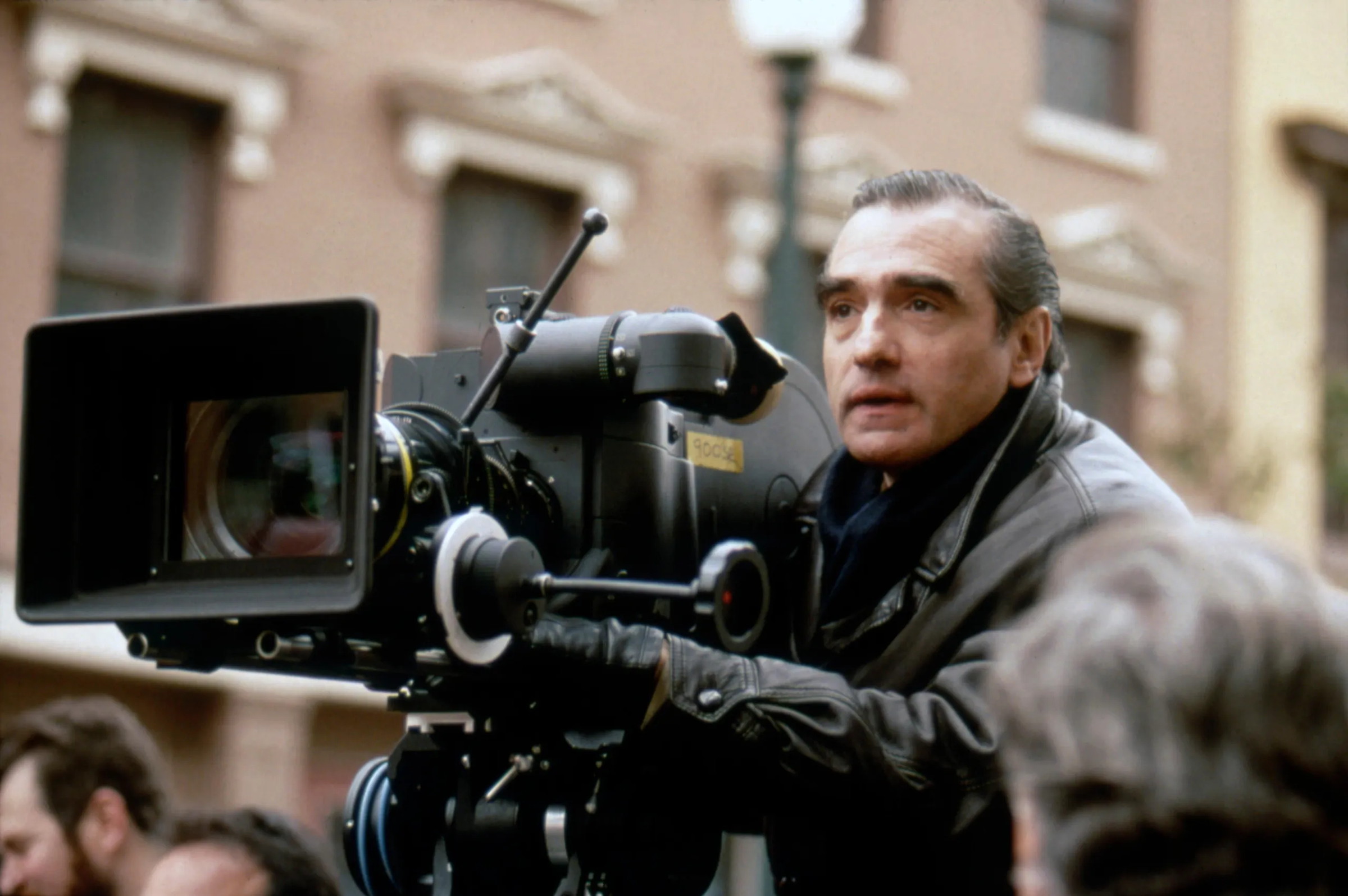 Martin Scorsese beside a film camera on a New York street