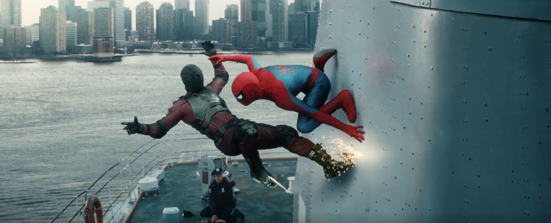 Spider-Man fights an armored opponent along the side of a ship with a city skyline across the water.