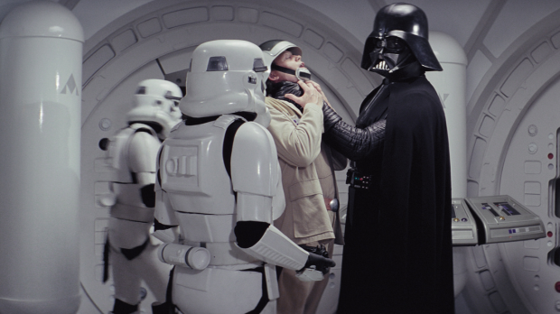 Darth Vader lifts a Rebel soldier by the throat as stormtroopers surround them aboard the Tantive IV.