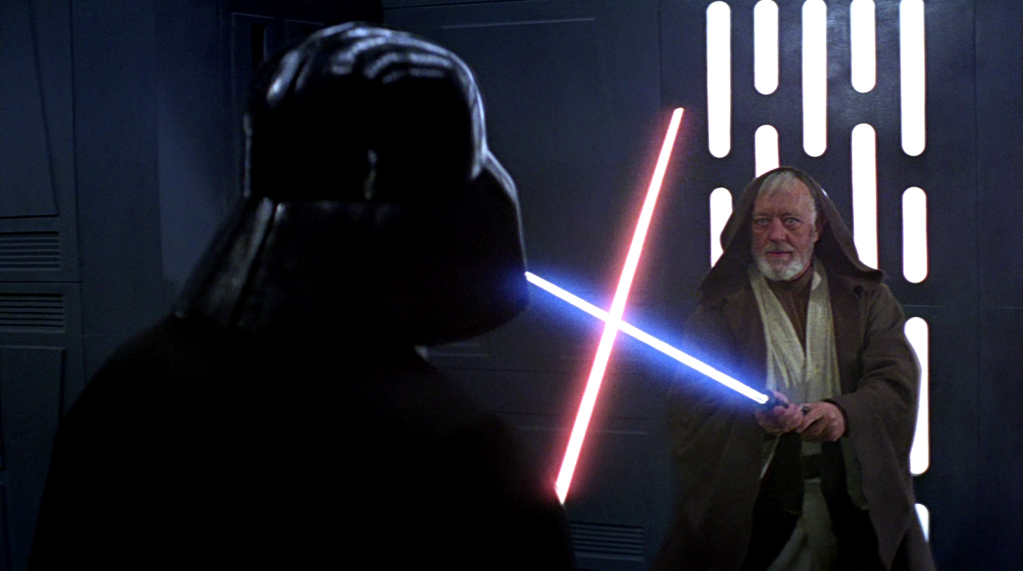 Obi-Wan Kenobi faces Darth Vader with a blue lightsaber as Vader holds a red lightsaber aboard the Death Star.