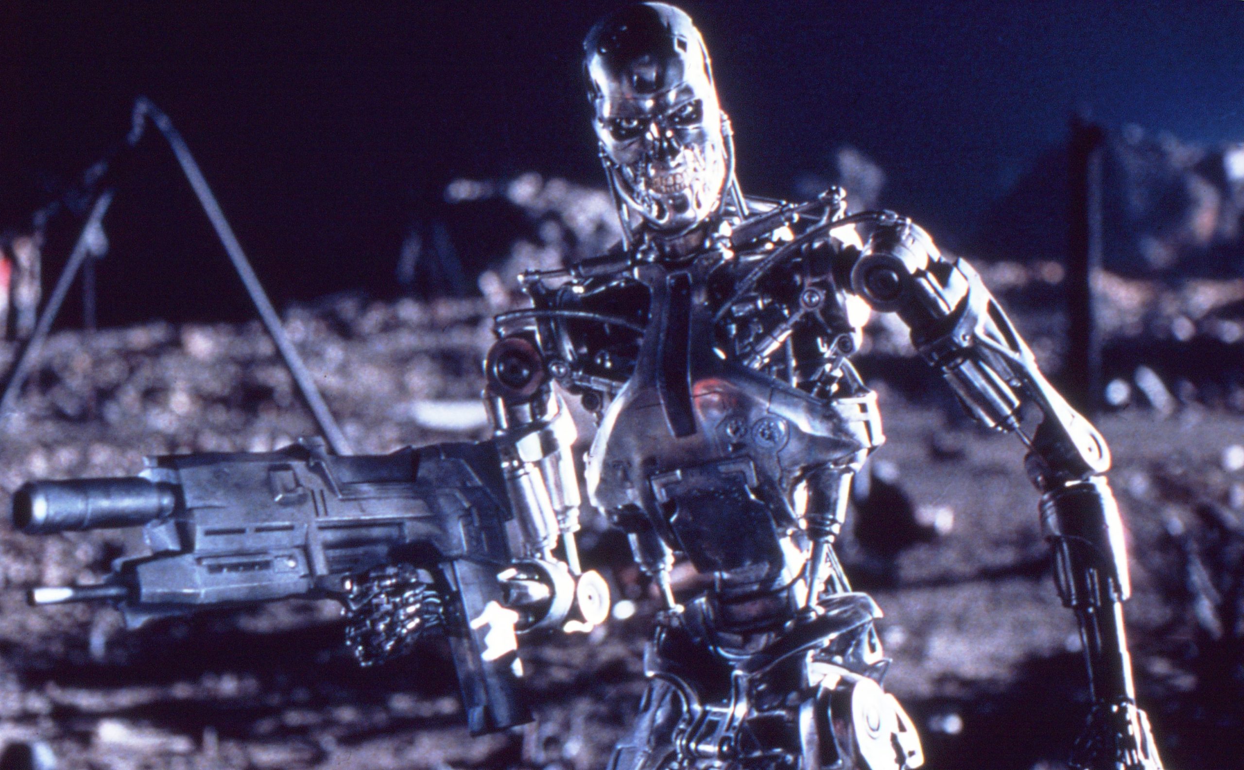A chrome Terminator endoskeleton stands armed against the ruins of a future battlefield in Terminator 2: Judgment Day.