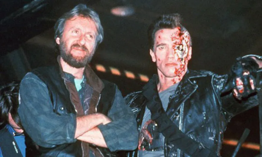 James Cameron stands beside Arnold Schwarzenegger in partially exposed Terminator makeup during the production of Terminator 2.