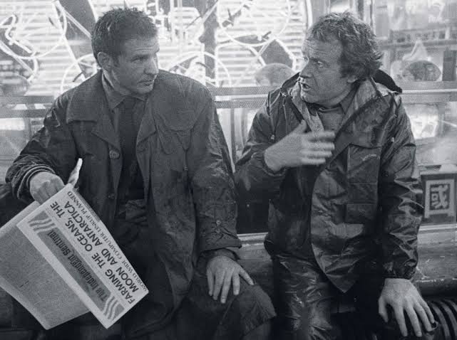 Harrison Ford sits beside director Ridley Scott during the production of Blade Runner.