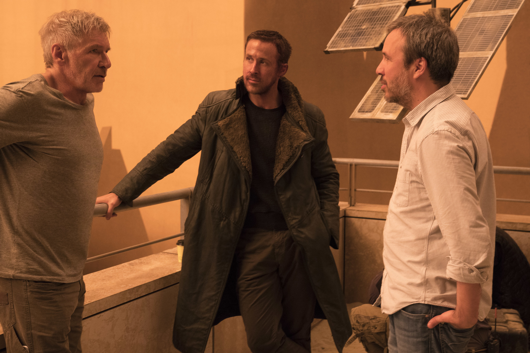 Harrison Ford, Ryan Gosling and director Denis Villeneuve stand together on the set of Blade Runner 2049.