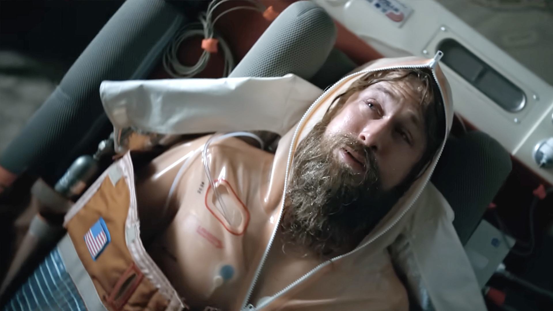 Ryan Gosling lies inside a spacecraft wearing a mission suit in Project Hail Mary.