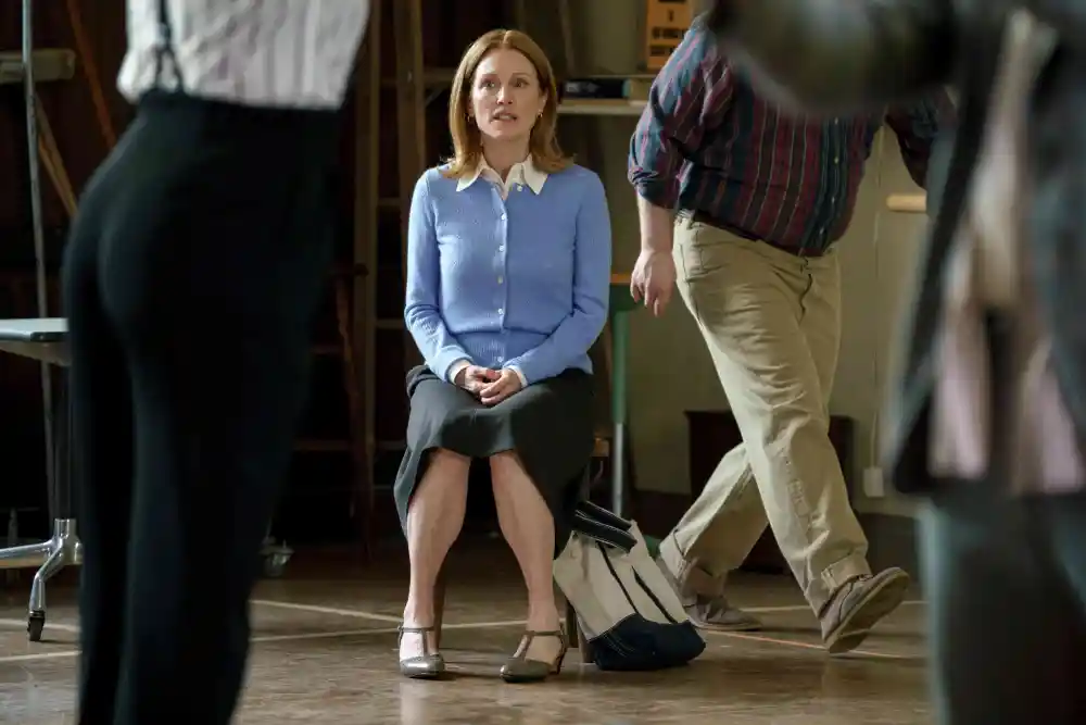 Julianne Moore sits in a rehearsal space wearing a light blue cardigan.