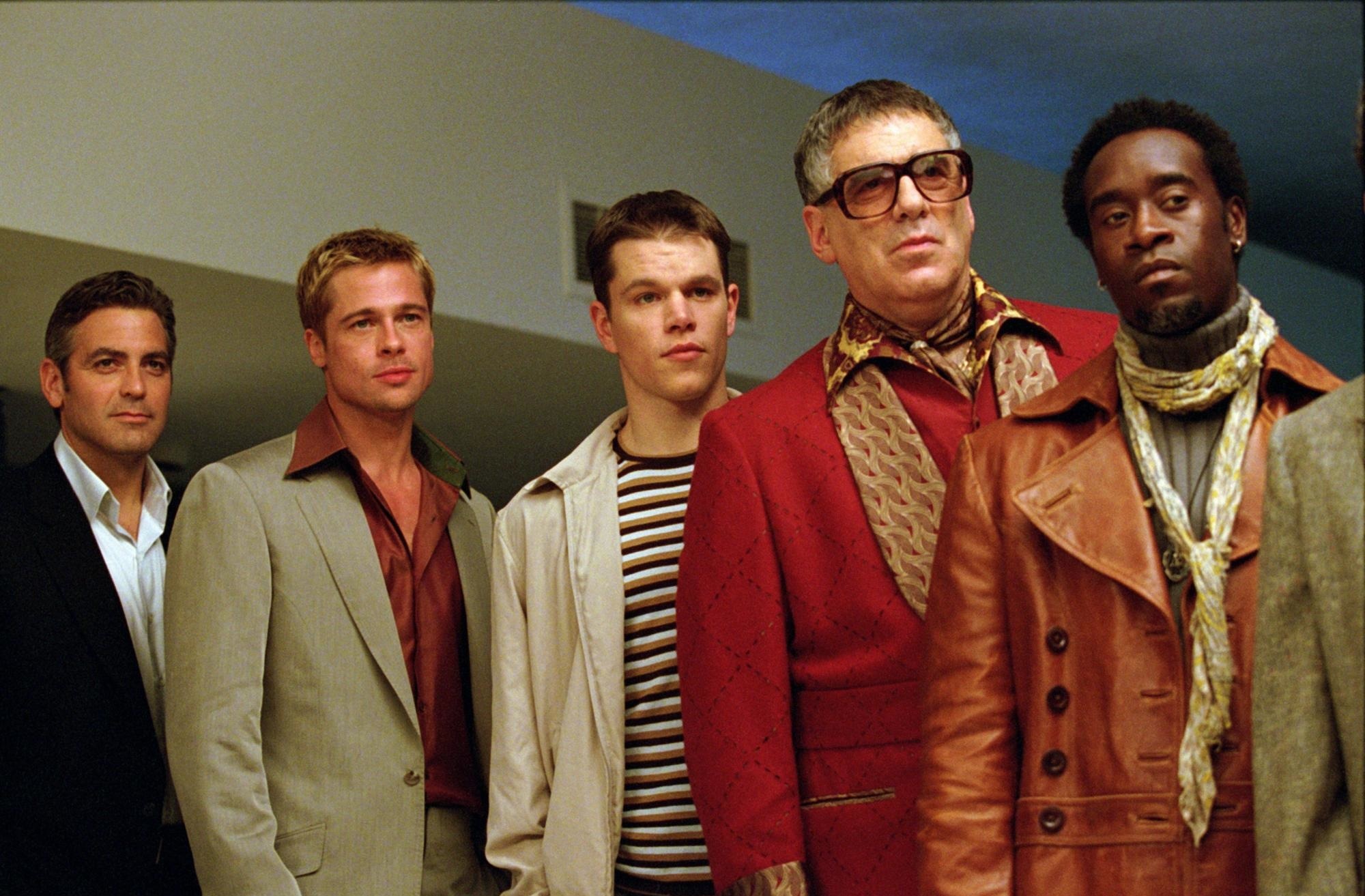 The principal members of the Ocean's Eleven crew stand together looking toward the camera.