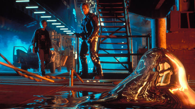 The liquid-metal T-1000 rises from the floor while the T-800 and John Connor look on in Terminator 2: Judgment Day.
