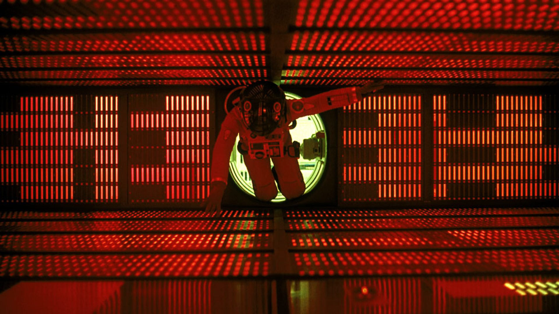 An astronaut moves through a red-lit corridor in 2001: A Space Odyssey.