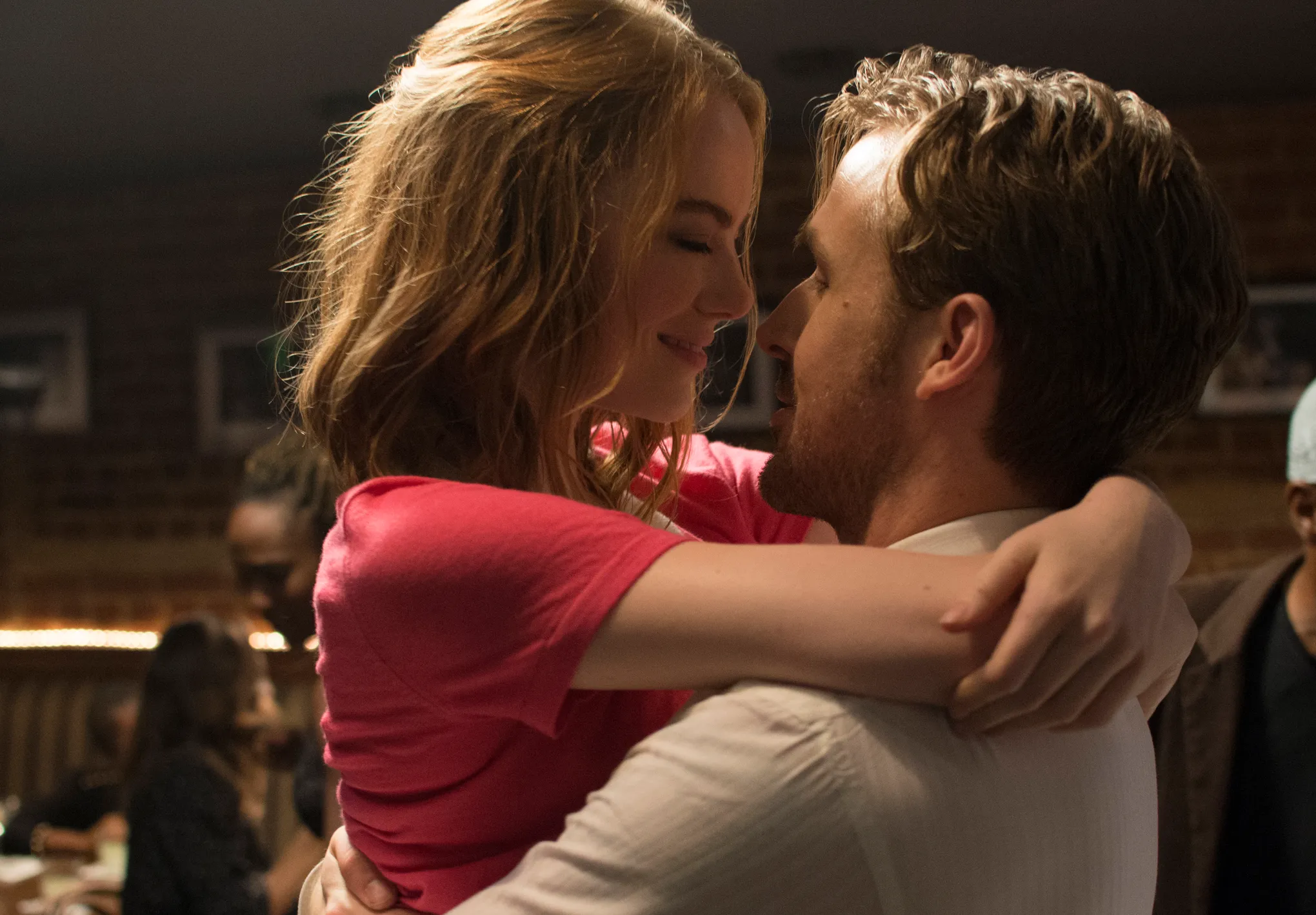 Emma Stone embraces Ryan Gosling during a romantic scene in La La Land.