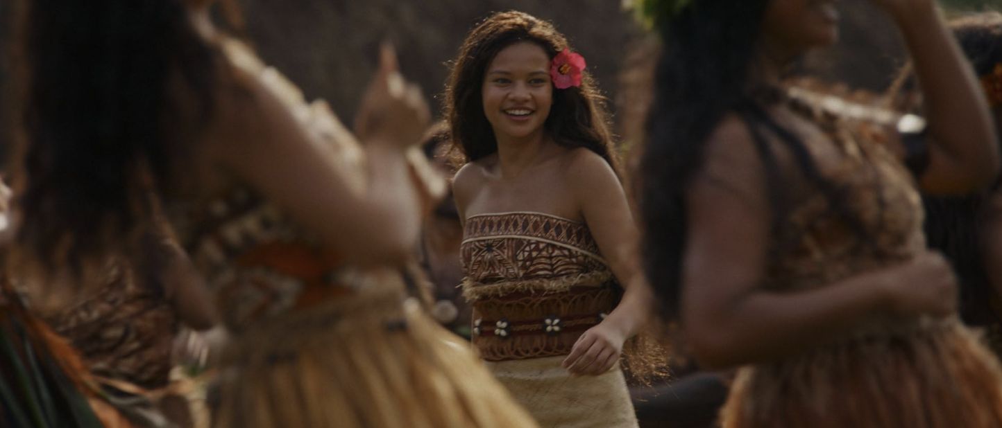Moana standing on her canoe against the open ocean