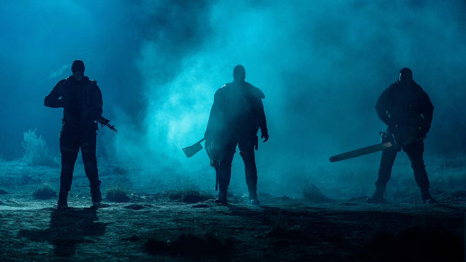 Three armed figures stand in silhouette in heavy blue fog at night.