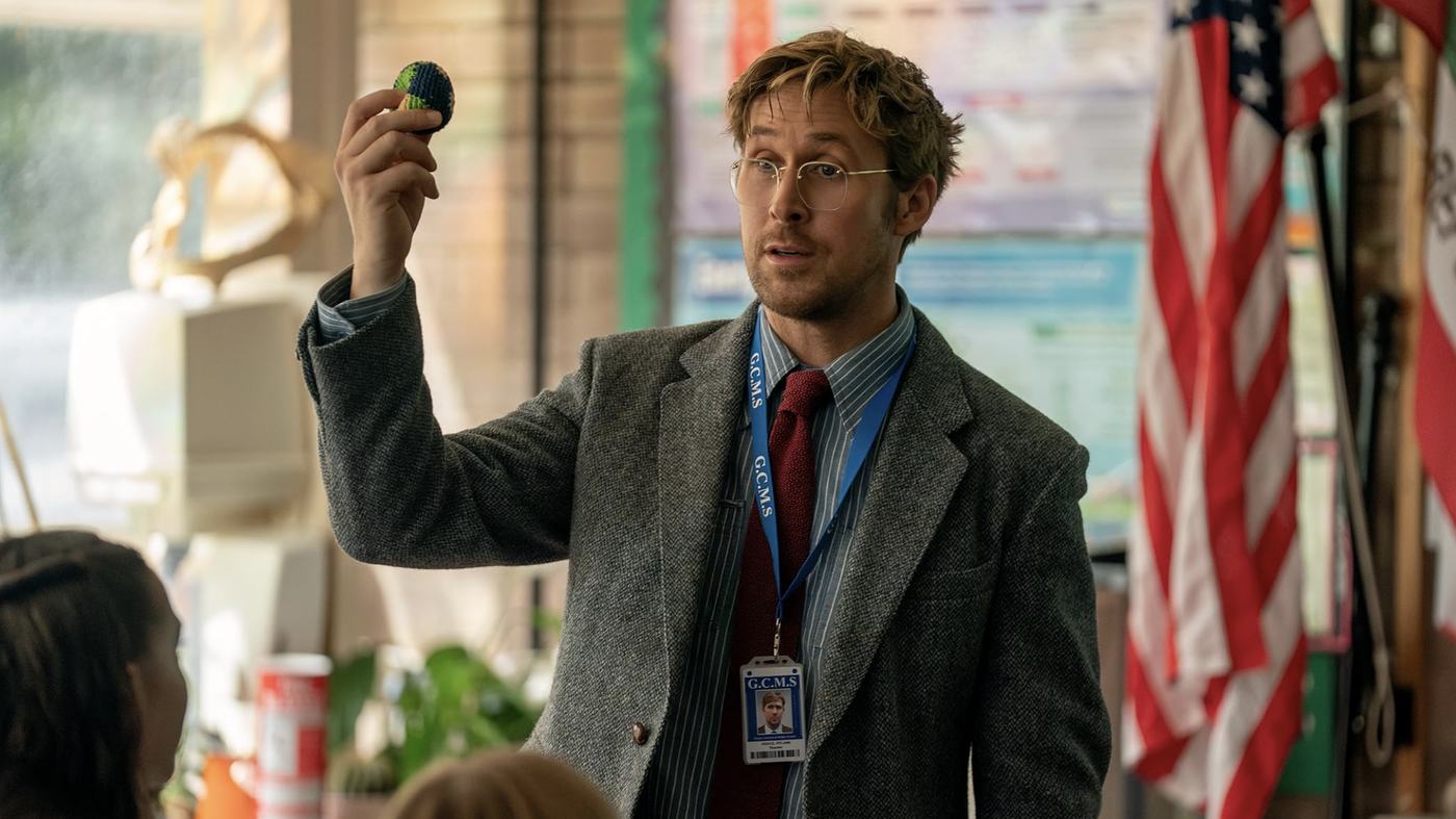 Ryland Grace teaching a science class, holding up a small object