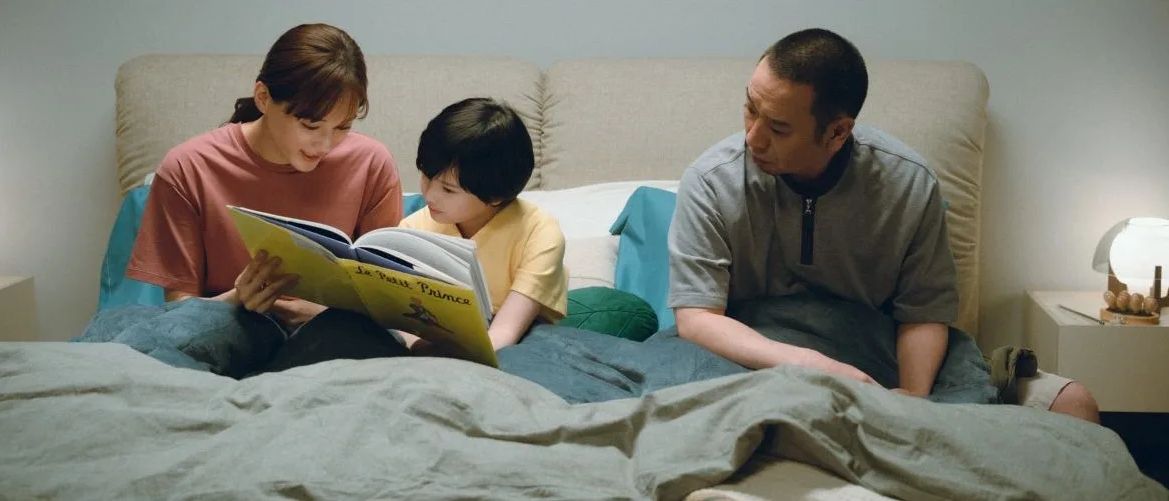 A family reading together in bed