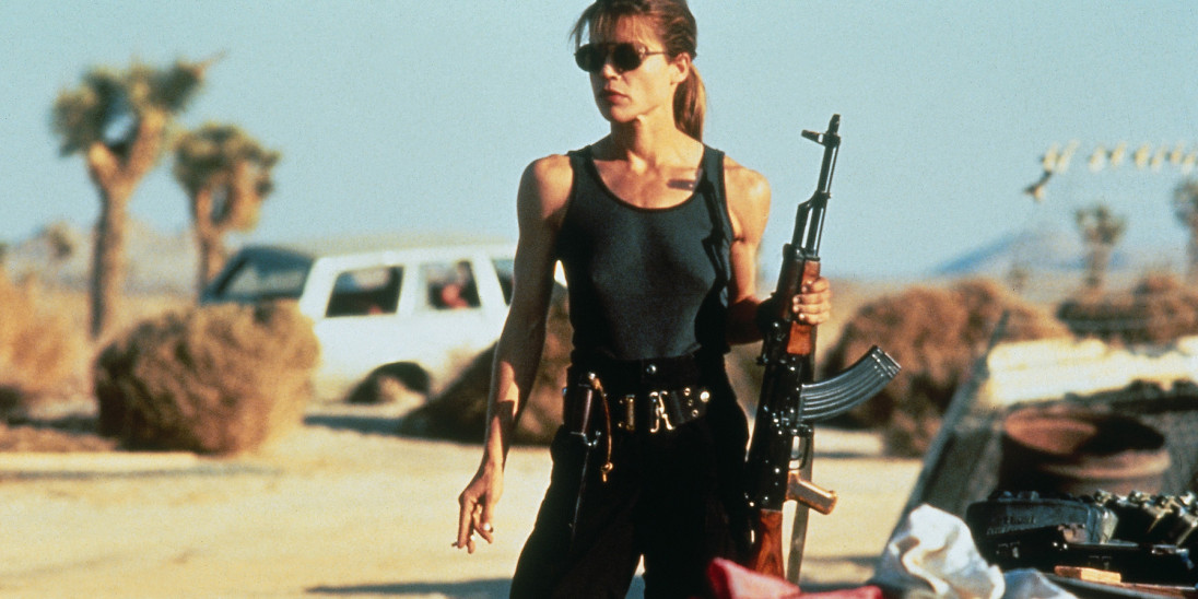 Linda Hamilton as Sarah Connor stands armed in the desert in Terminator 2: Judgment Day.