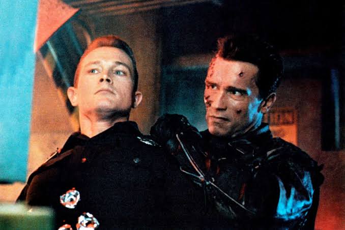 Robert Patrick as the T-1000 stands beside Arnold Schwarzenegger’s T-800 in Terminator 2: Judgment Day.