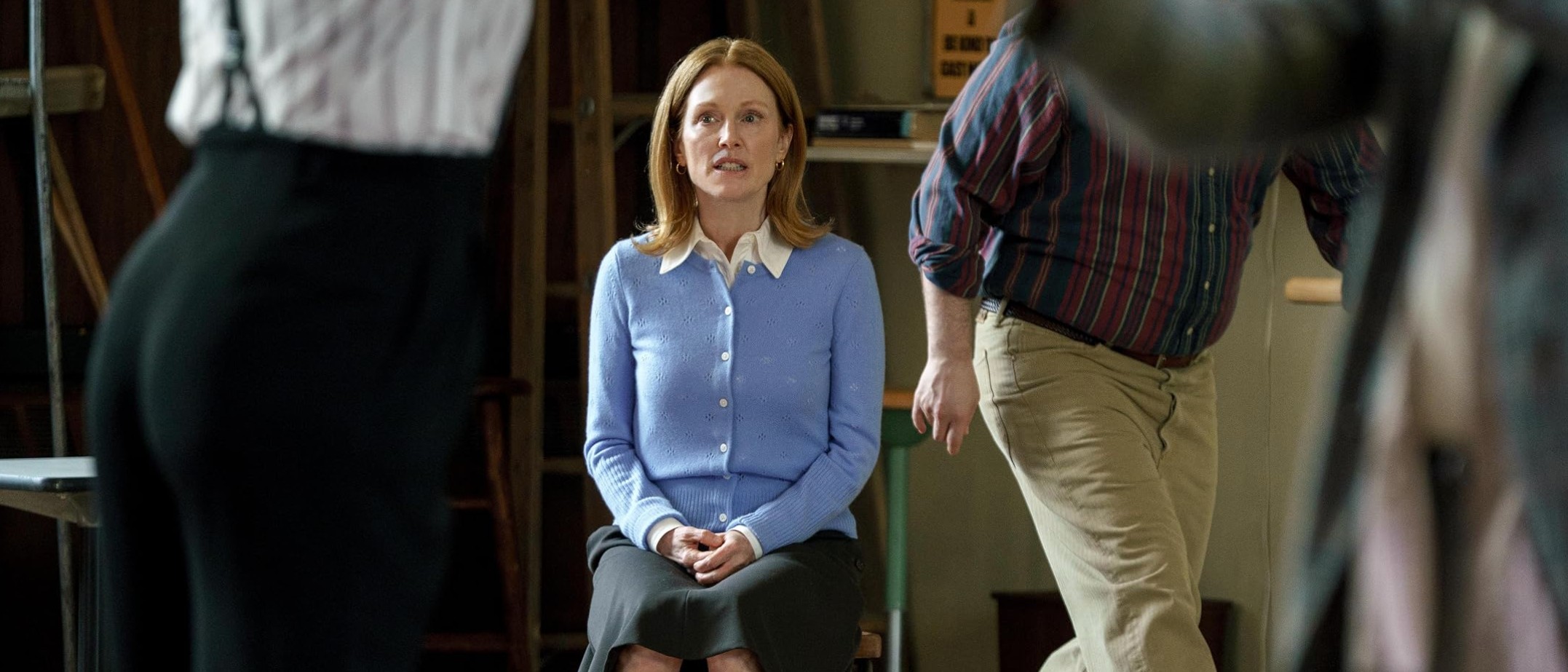 Julianne Moore sits in a rehearsal space wearing a light blue cardigan