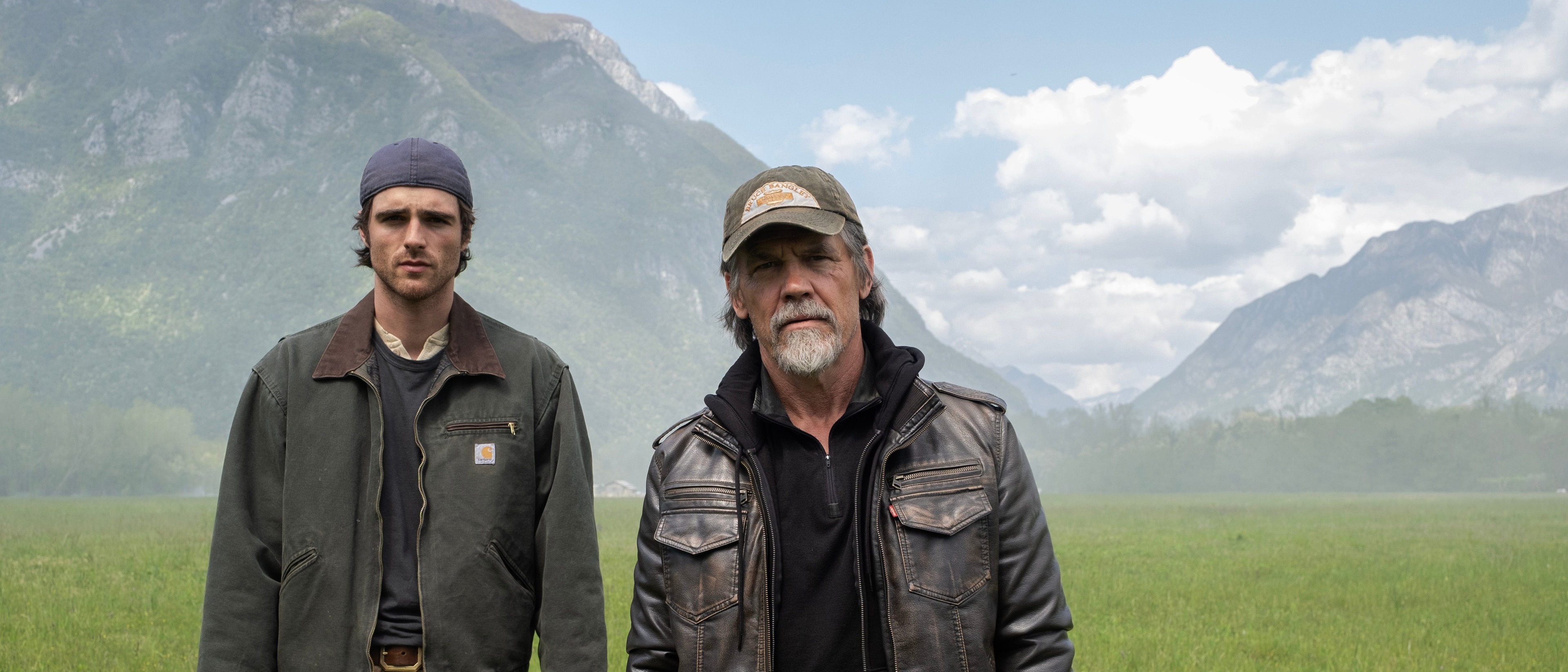 Jacob Elordi and Josh Brolin stand in an open mountain valley in The Dog Stars.