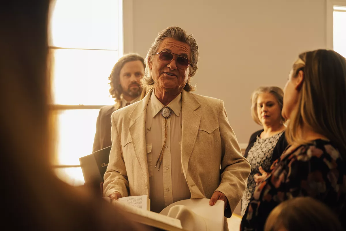 Kurt Russell wears a light-colored Western suit and sunglasses in The Rivals of Amziah King.