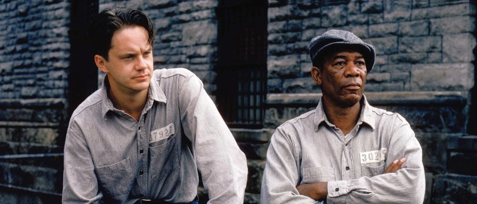 Andy Dufresne and Red sitting together in the prison yard
