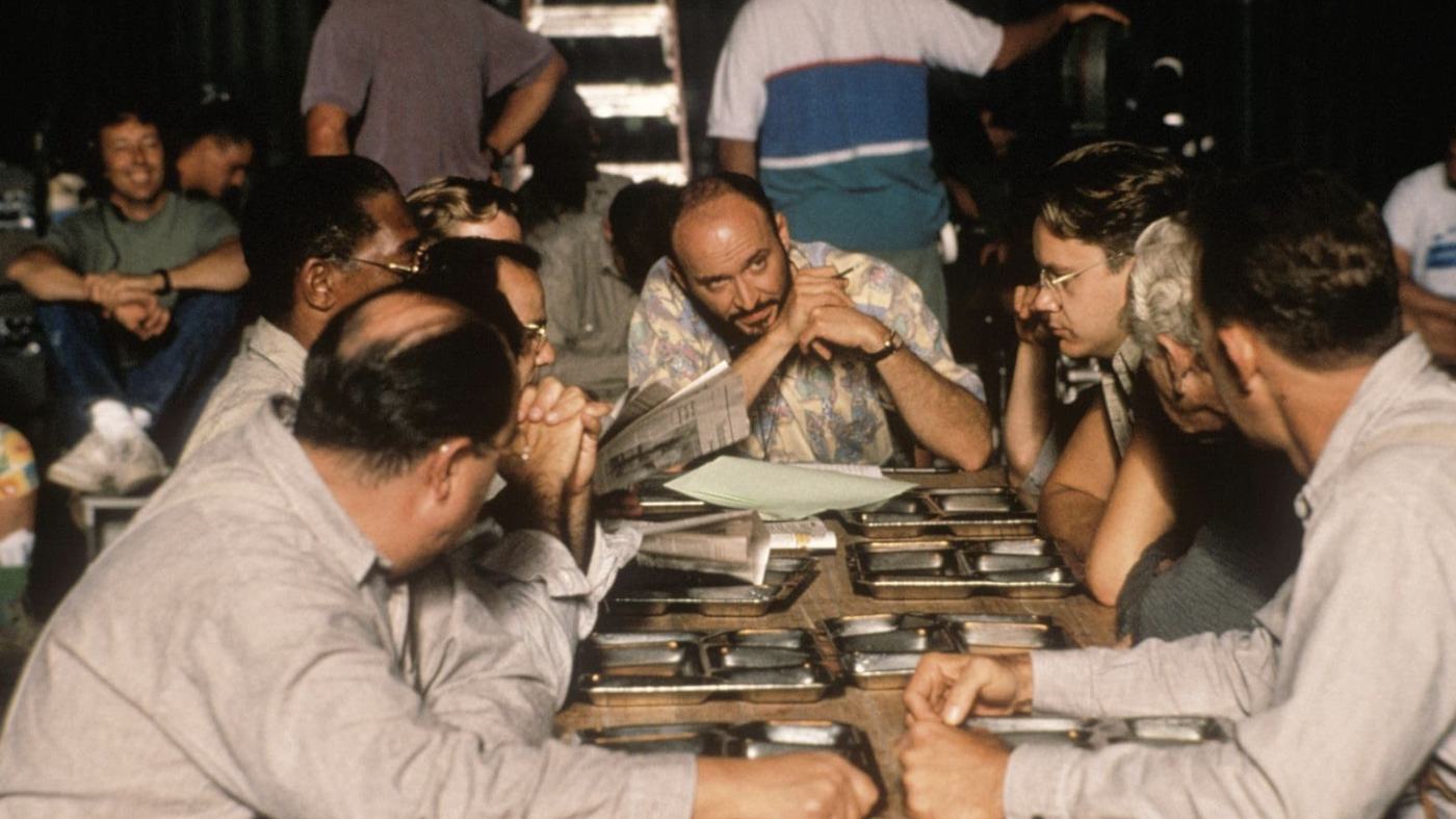 Crew members reviewing shots at a table on the Shawshank set