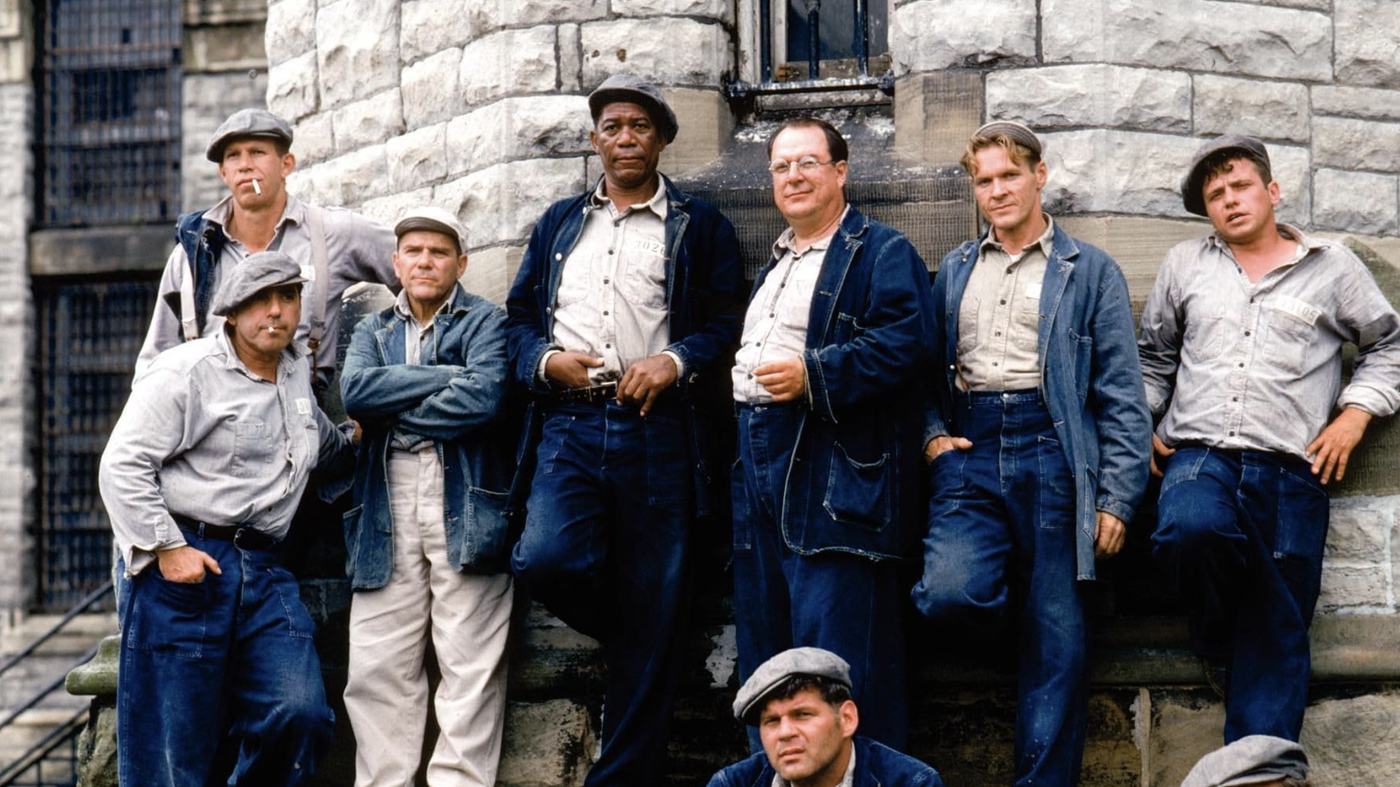 Red, Andy, and the rest of the Shawshank yard crew on the cellblock steps