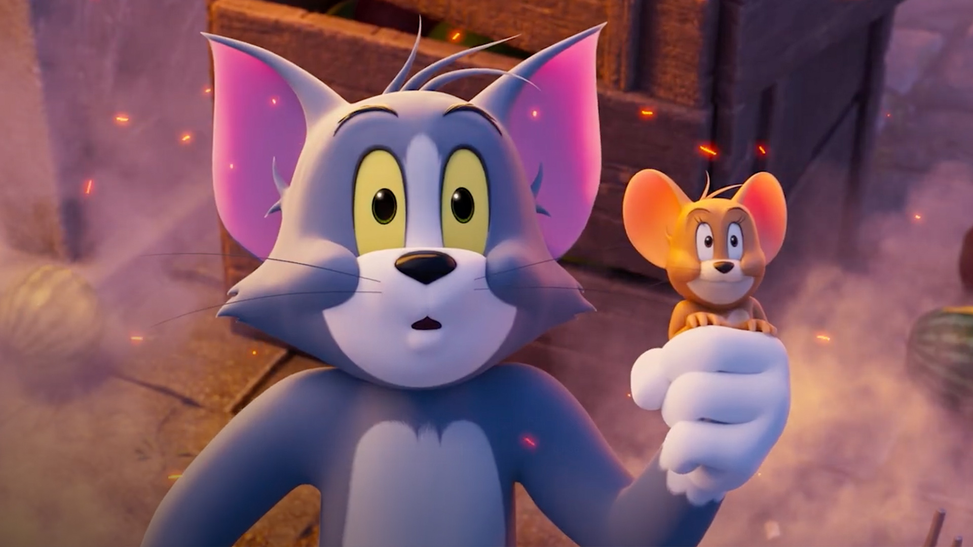 Tom looks surprised while holding Jerry in one hand amid smoke and glowing embers.