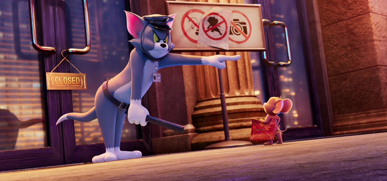 Tom, dressed as a security guard, points Jerry away from a museum exhibit while holding a baton.